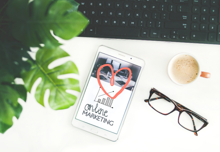 What is Ethical Marketing - top view of desk with keyboard, i-pad, plant, glasses and coffee mug